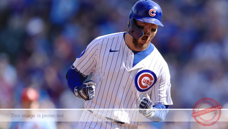 Busch stars as the Cubs beat the Cardinals 7-3 to clinch the top NL wild card